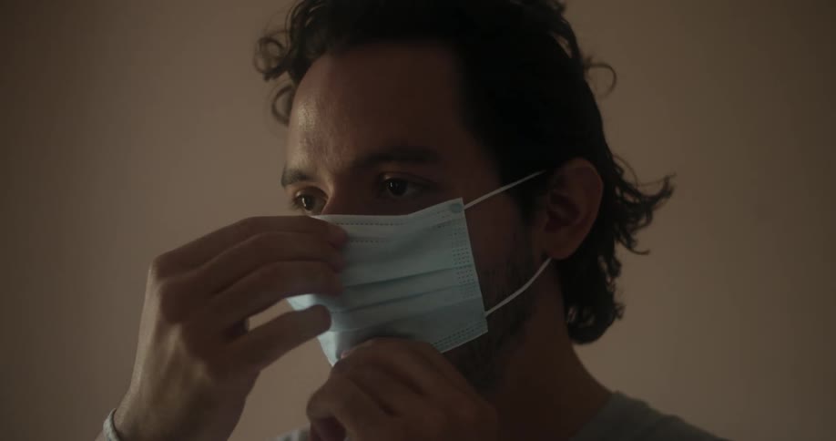 A man puts on a medical mask