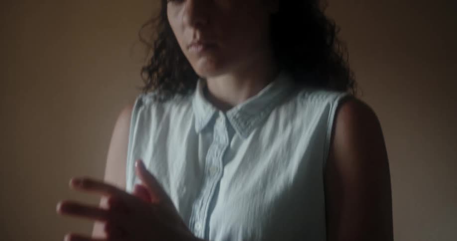 A woman standing rubbing her hands
