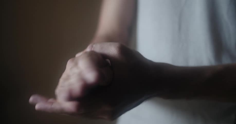 Person sprays hand sanitizer then rubs hands together