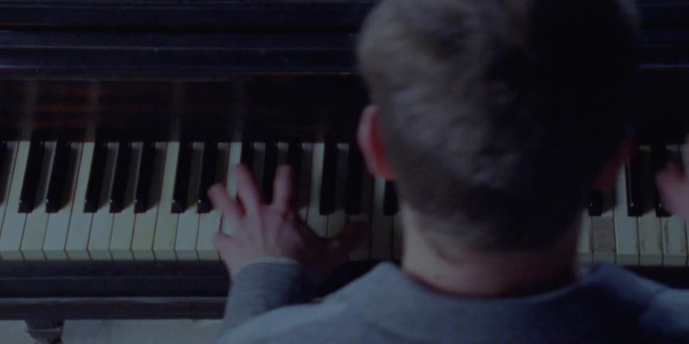 A man plays the piano intensely