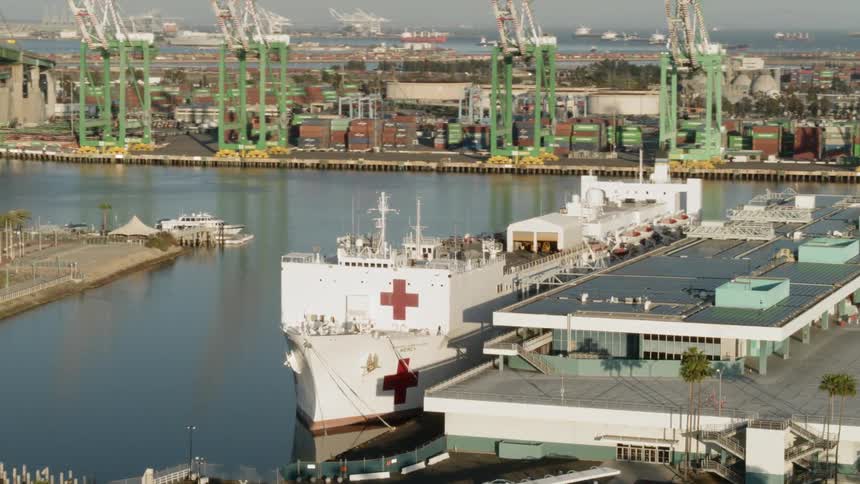 A hospital ship docked at a shipyard