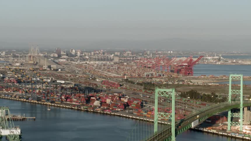A bridge over a river leads to a dense city