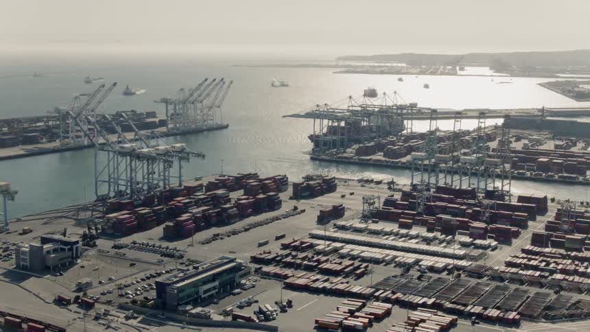 Aerial view of a port with a harbor on the coast protected from the open sea by strong walls where ships can shelter
