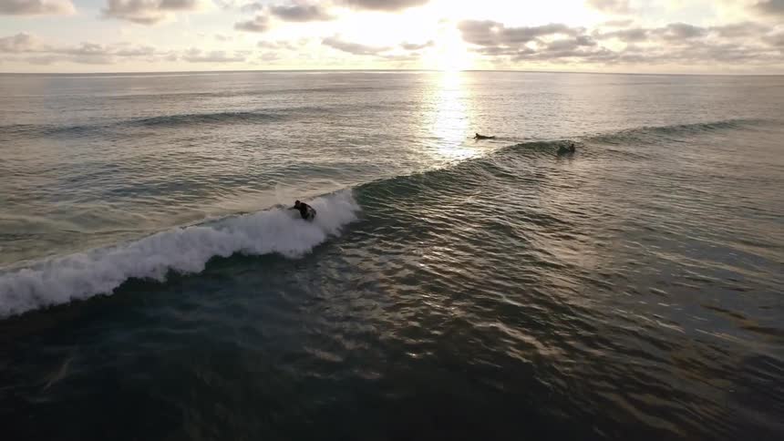 A surfer crashes on an ocean wave