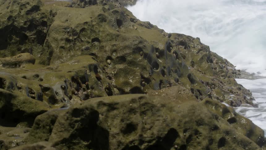 Water crashes into rocks on the shore