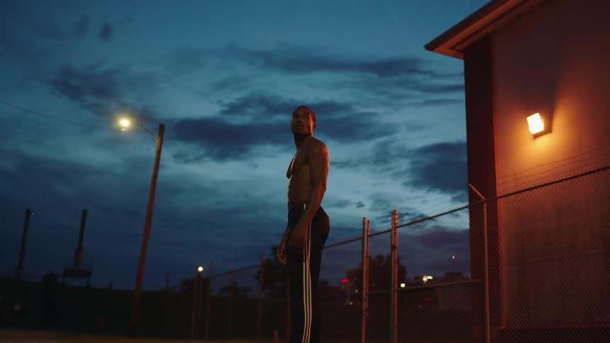 A man stands outside at night