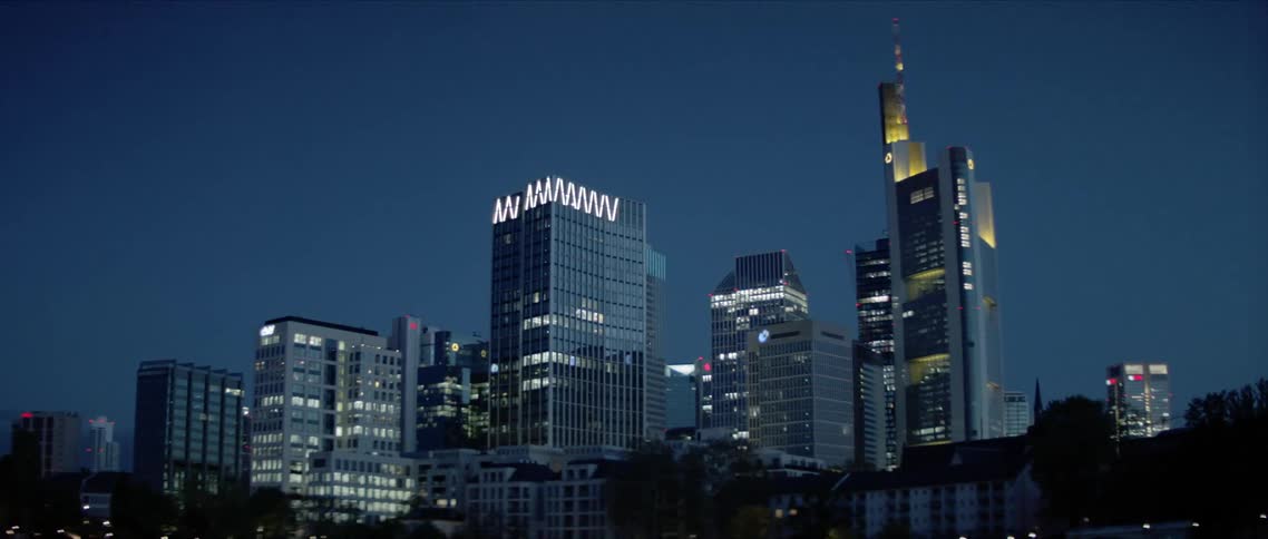 A bridge and city skyline are lit up at night
