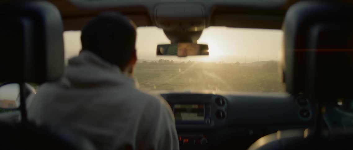 A man sits inside his car