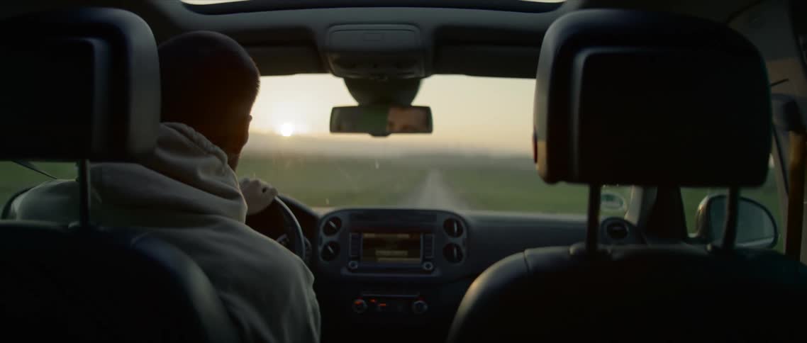 A man drives down a street