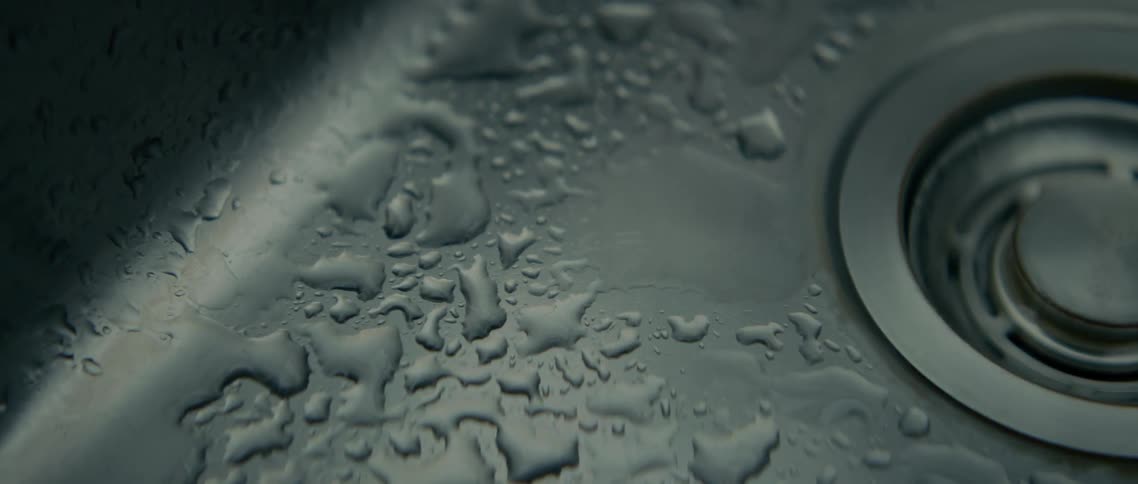Water dripping in a silver sink