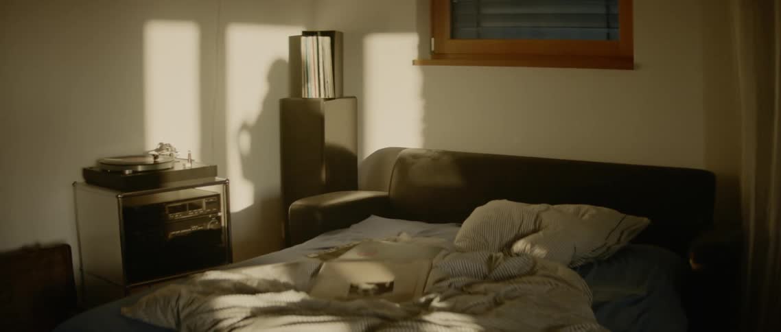 A person casts a shadow on the wall while dancing