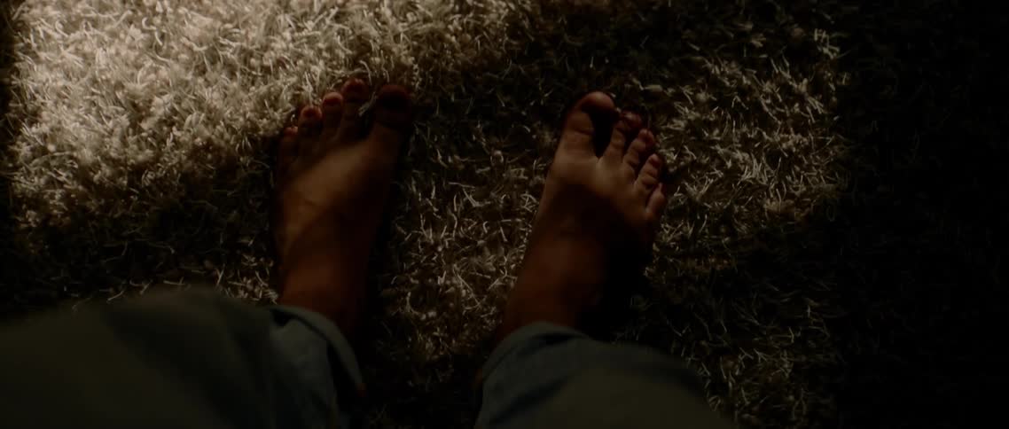Birds eye view of a mans feet on the carpet