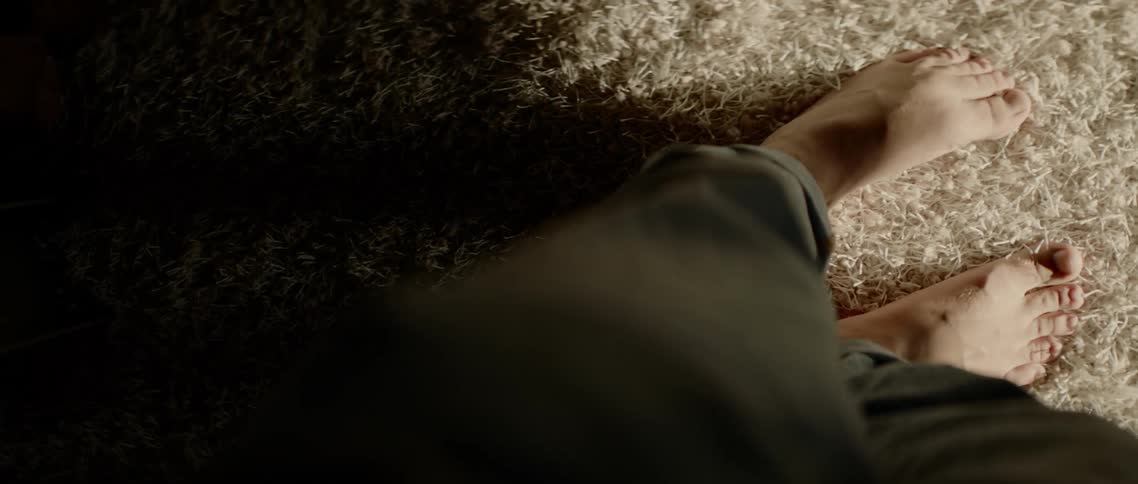 Birds eye view of a mans feet on carpet
