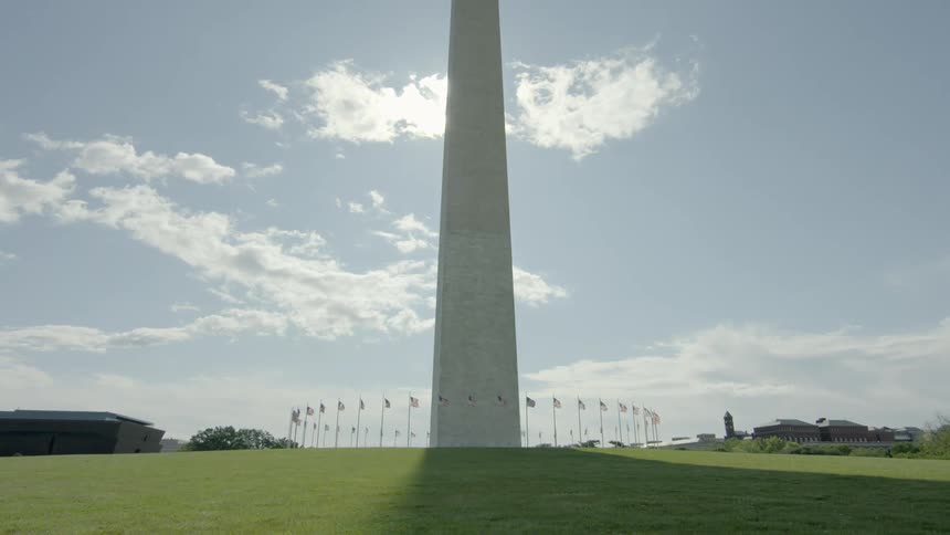 A monument surrounded by american flags