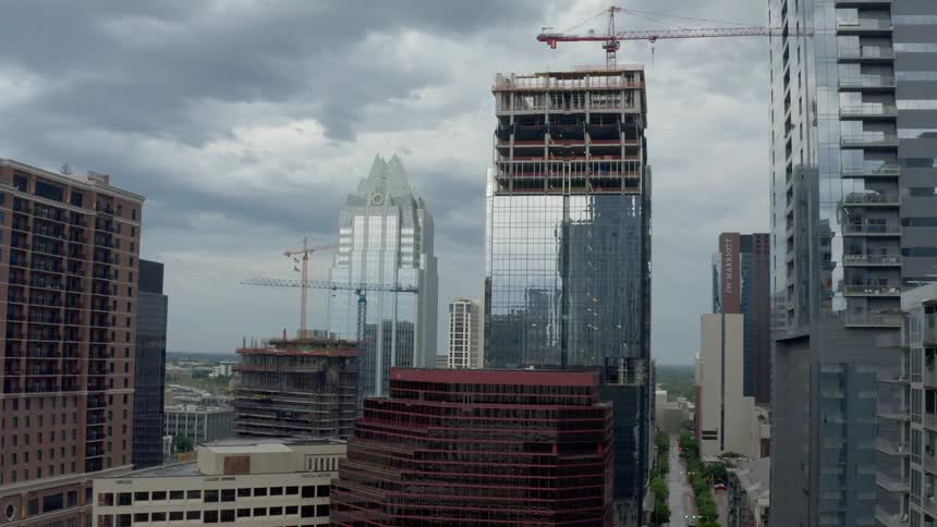 Skyscrapers sit under a cloudy sky