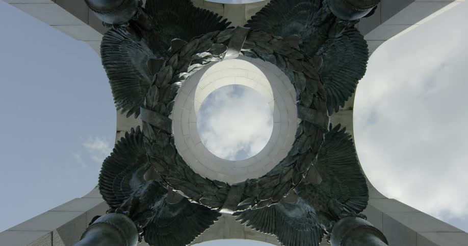 Clouds can be seen passing over head through ring in center of sculpture and structure