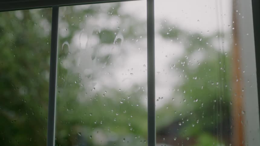 A man puts his hand on the window