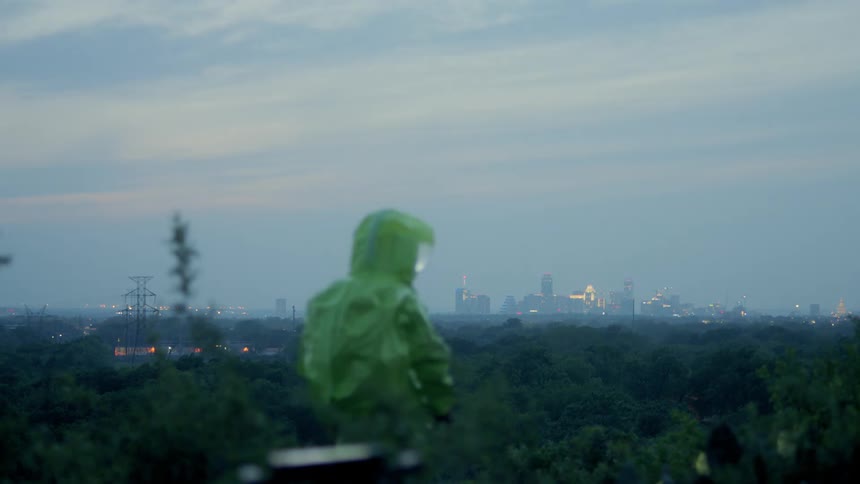 A person in a hazmat suit looks around