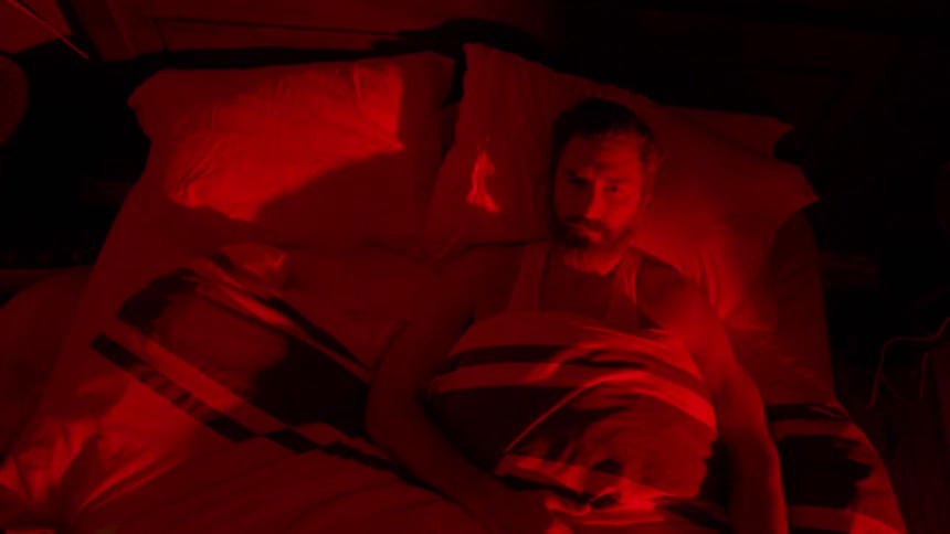 Birds eye view of a man lying in bed