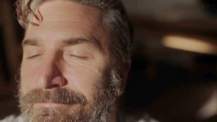 A man stares into light blinking