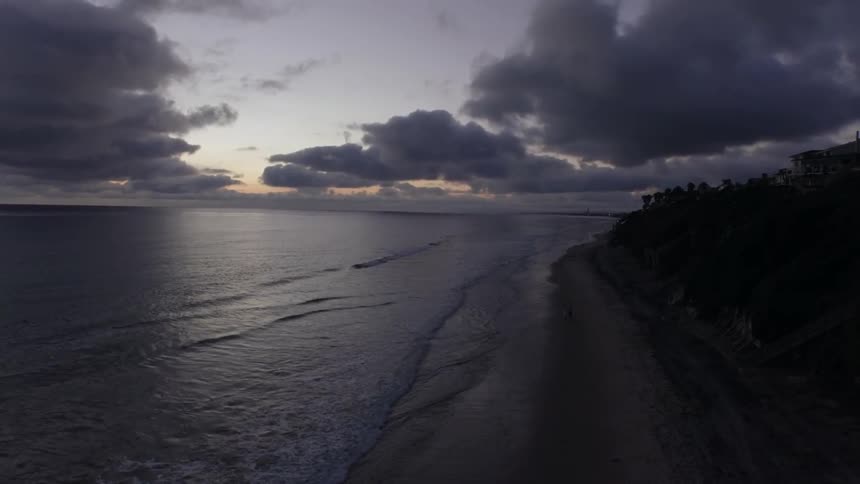 Waves lapping on a beach at dusk