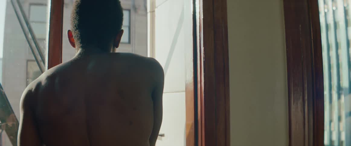 A man gets up from the window and walks