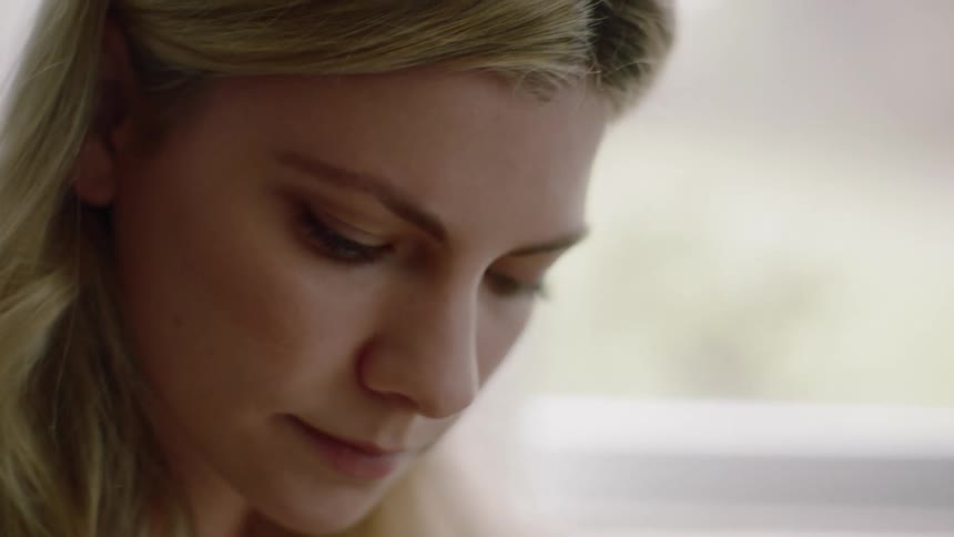 Blonde woman reading a book indoors