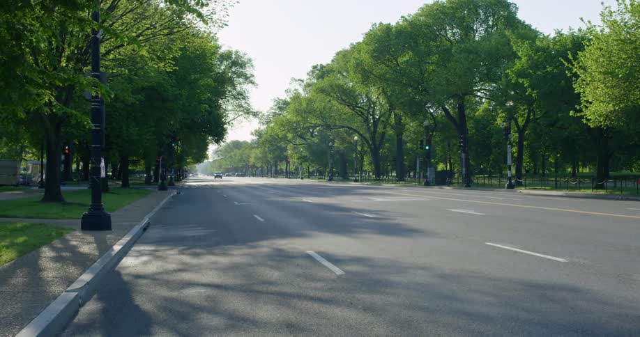 The large road is empty by the forest