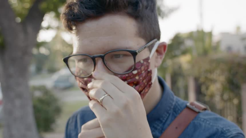 A man places a mask on his face