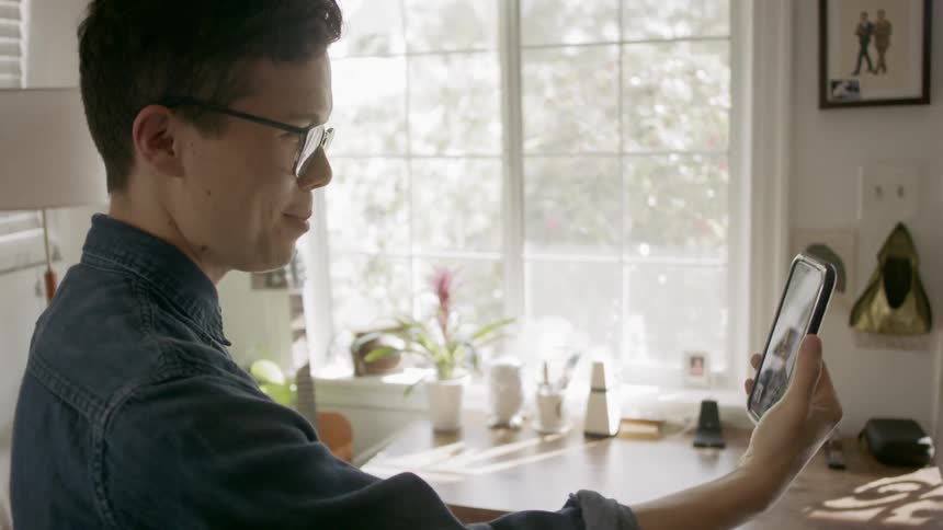 Two men video chat on a cell phone