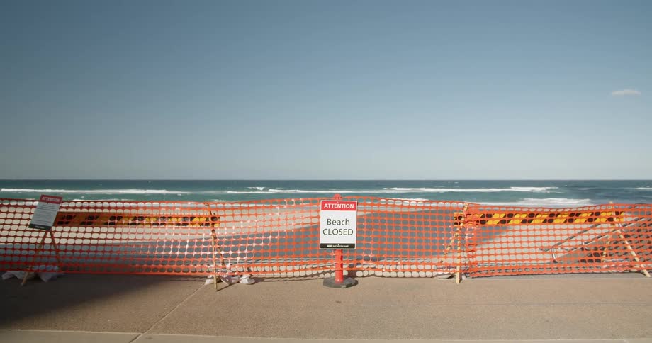 A sign in front of a closed beach