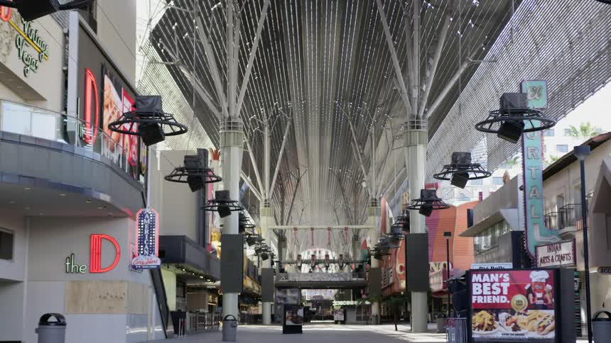 A mall with stores signs and lights