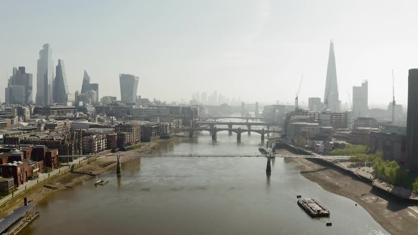 Multiple large bridges over a river connect a large city