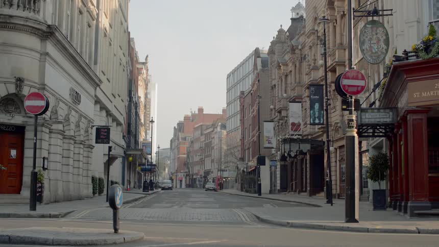 An empty european street with closed stores and buildings on both sides