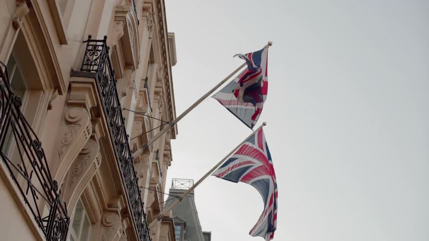A building with two union jacks waving in the wind