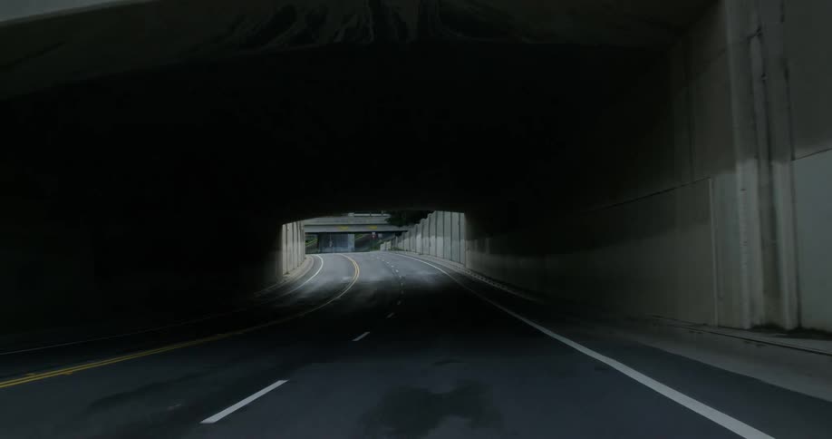 An empty city street that goes under an overpass