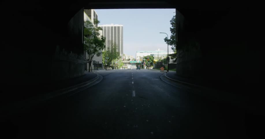 Vehicle drives through the tunnel into the city