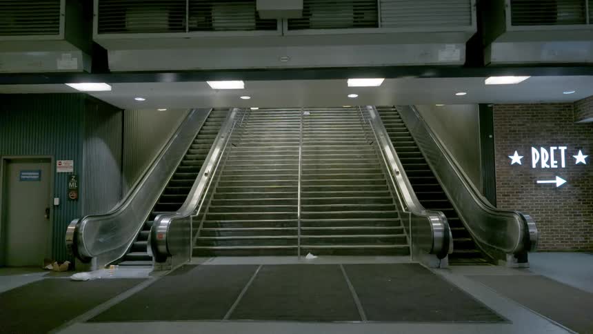 Escalator moving up and down in a deserted lobby