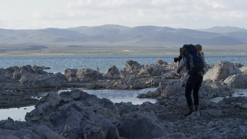 A hiker stops to take pictures of the scenery