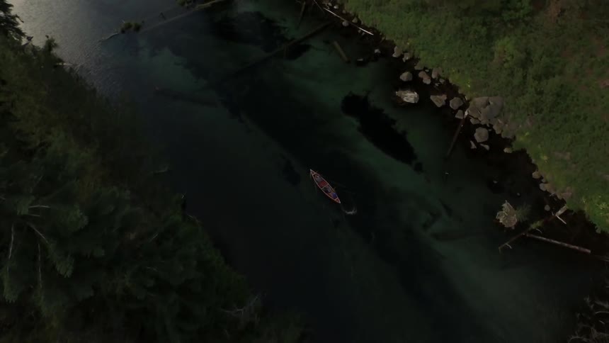 A boat paddling through a clear river
