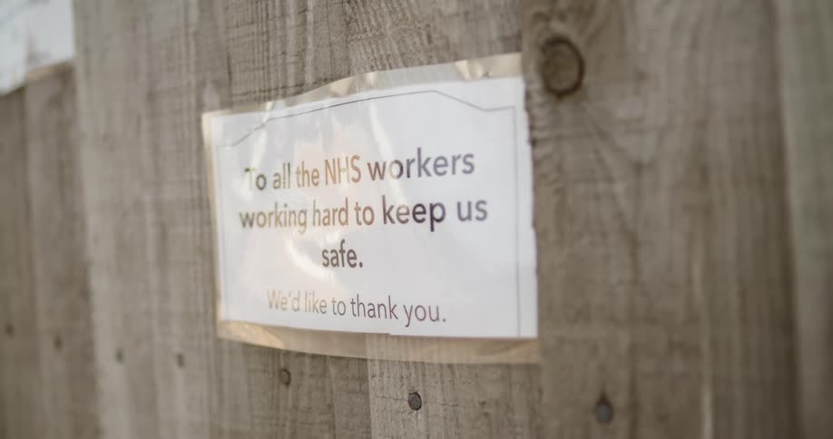 A sign hangs outside on a fence