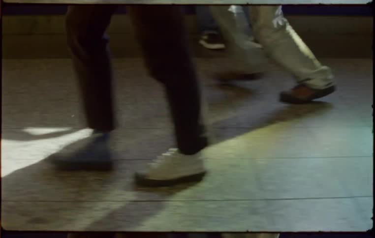 Man wearing different shoes walks down the corridor