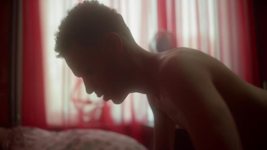 A teenager does push ups in his bed