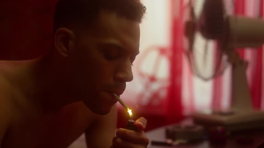 A man is smoking in a room