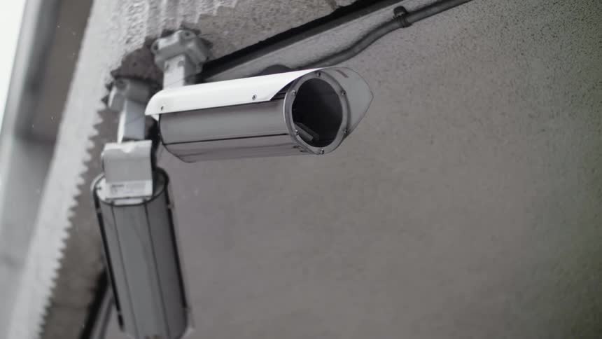 Security cameras a attached to a building with wires