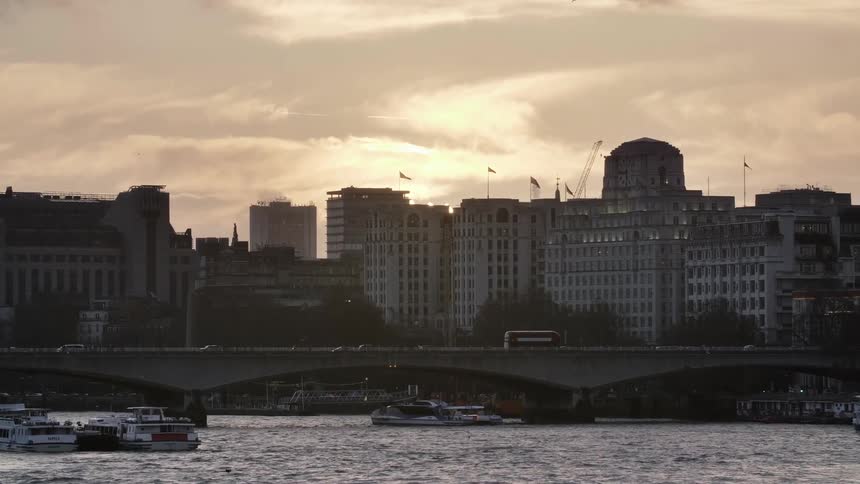 City skyline and vehicles crossing the bridge at dusk