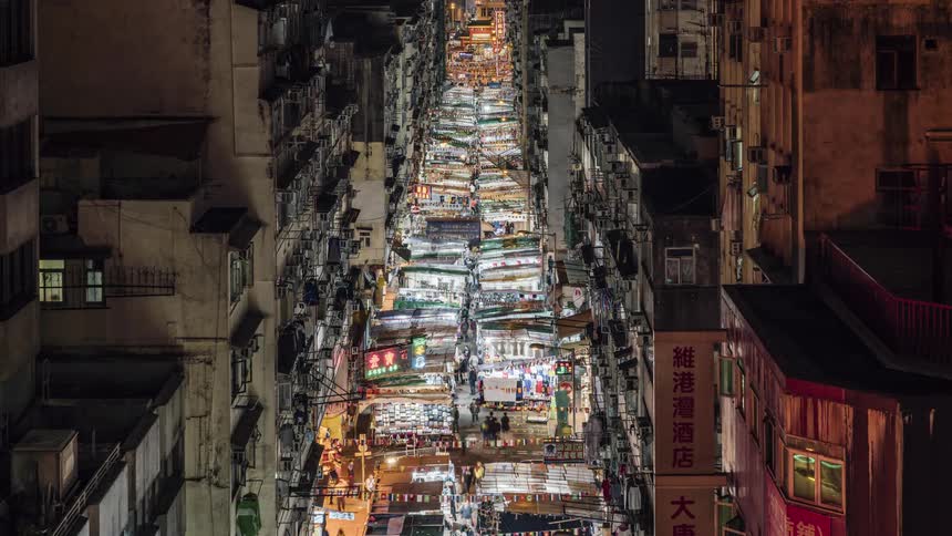 A city street with people markets and buildings