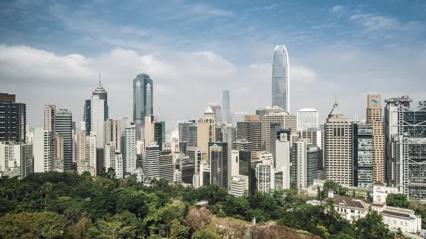 City skyline with clouds floating over the tall buildings and skyscrapers