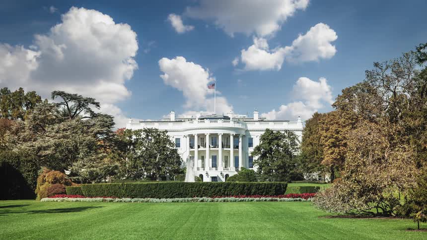 American flag standing above the white house