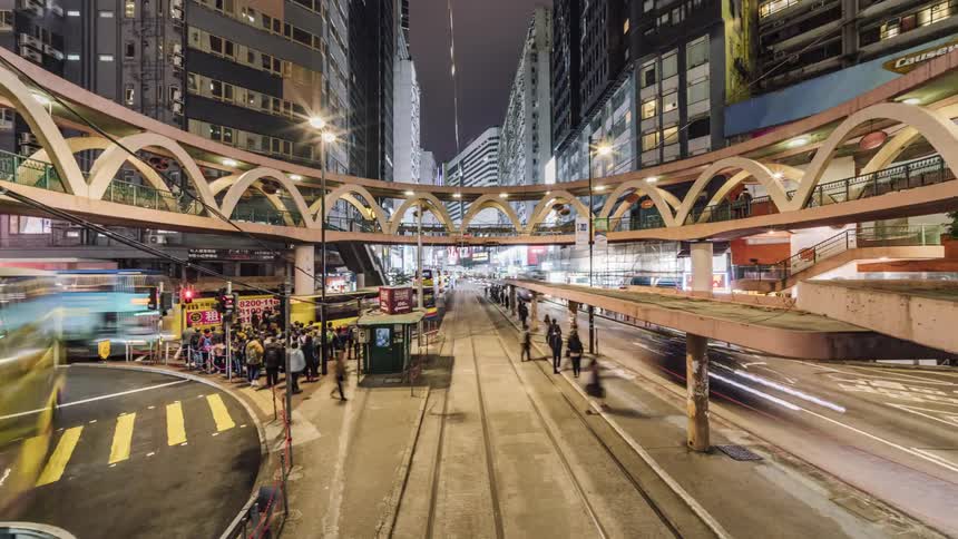 A timelapse of people are vehicles in a downtown city is displayed